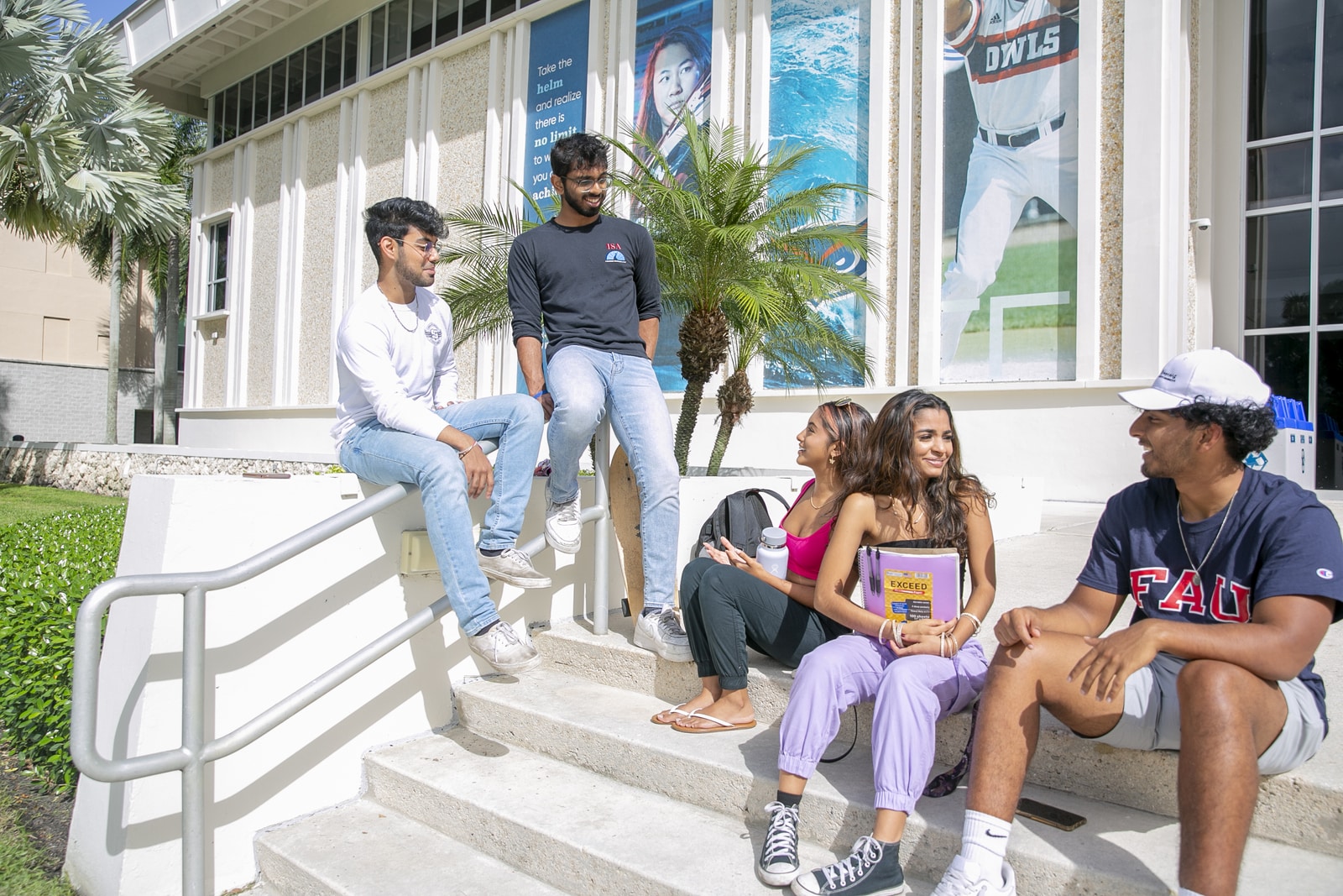 Students talking on steps to a building